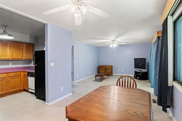 tiled dining room featuring ceiling fan