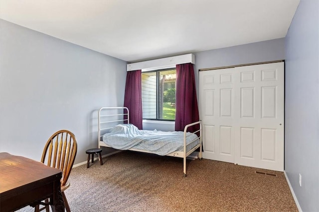 carpeted bedroom with a closet