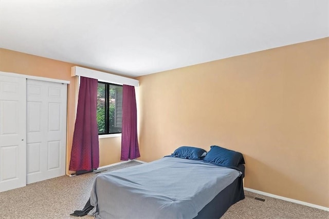 bedroom with a closet and carpet floors