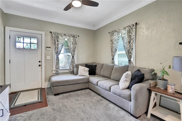 living room with a wealth of natural light, light colored carpet, and ornamental molding