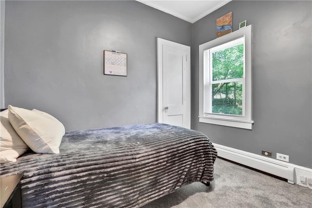 carpeted bedroom with a baseboard heating unit