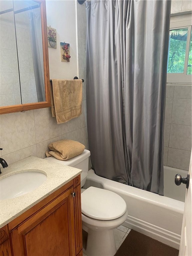 full bathroom featuring shower / bath combination with curtain, toilet, tile walls, and vanity