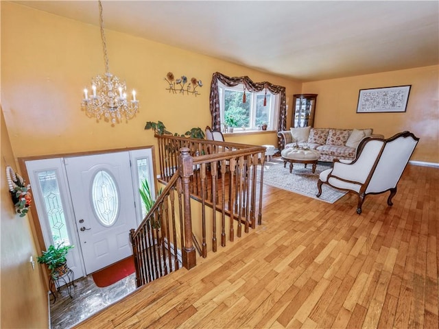 foyer featuring hardwood / wood-style floors and a notable chandelier