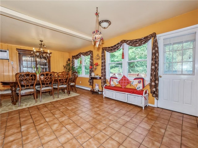 tiled dining room featuring a notable chandelier, plenty of natural light, and an AC wall unit