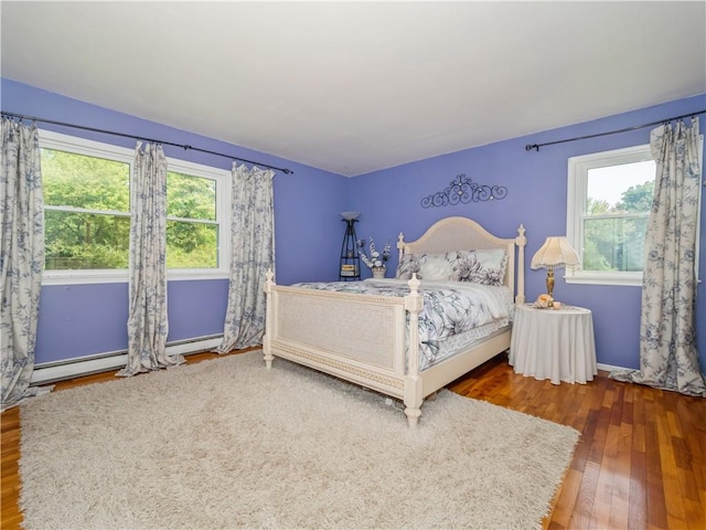 bedroom with multiple windows and dark wood-type flooring