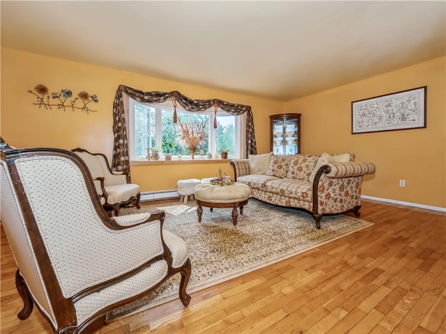 living area featuring baseboard heating and wood-type flooring