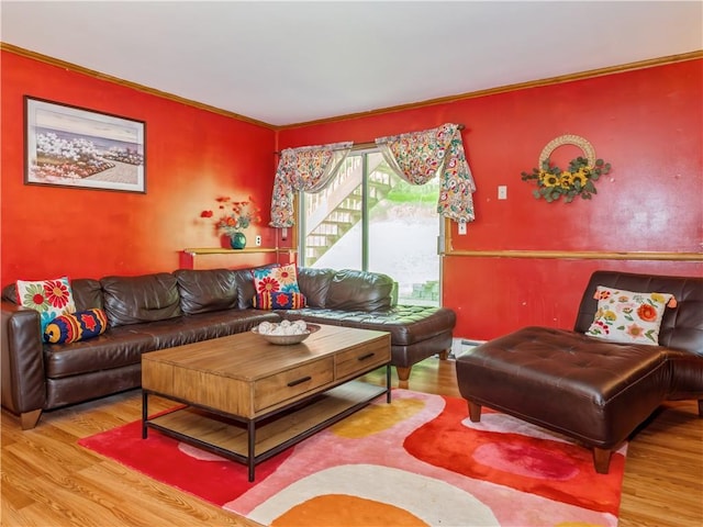 living room with hardwood / wood-style flooring and ornamental molding