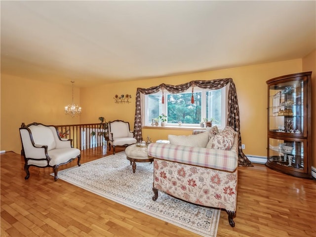 living room with a chandelier, wood-type flooring, and a baseboard radiator