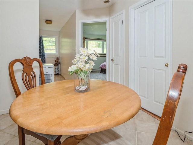 dining room featuring light tile patterned floors and a baseboard radiator