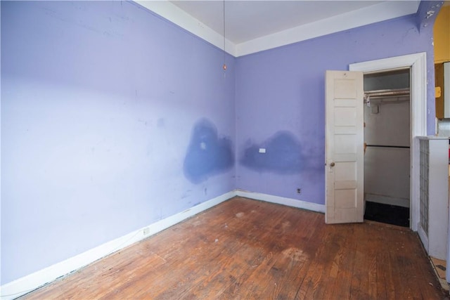 unfurnished bedroom with a closet and wood-type flooring