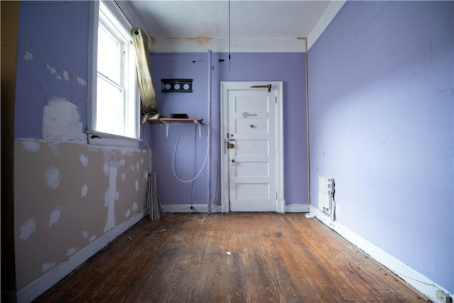 unfurnished room featuring dark wood-type flooring