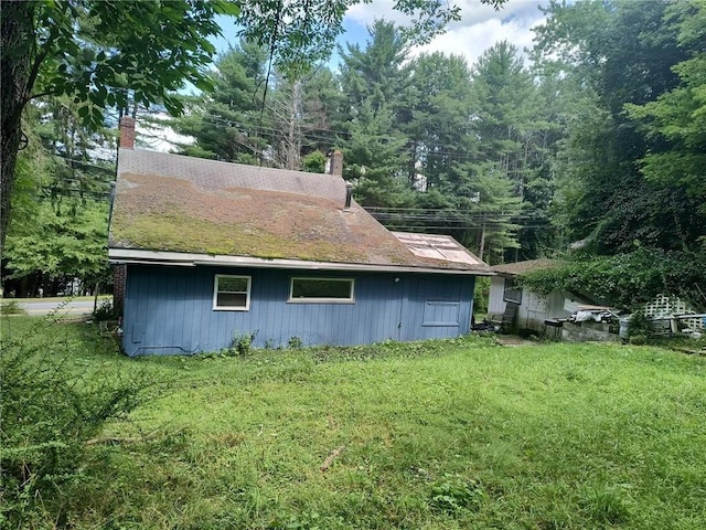 view of side of property with a lawn