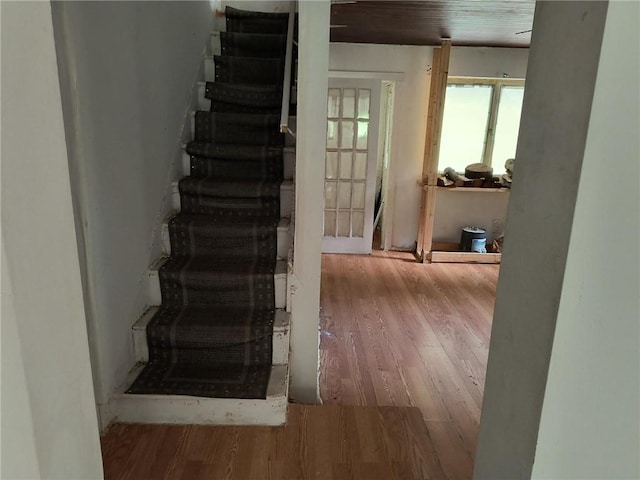 stairs featuring wood-type flooring