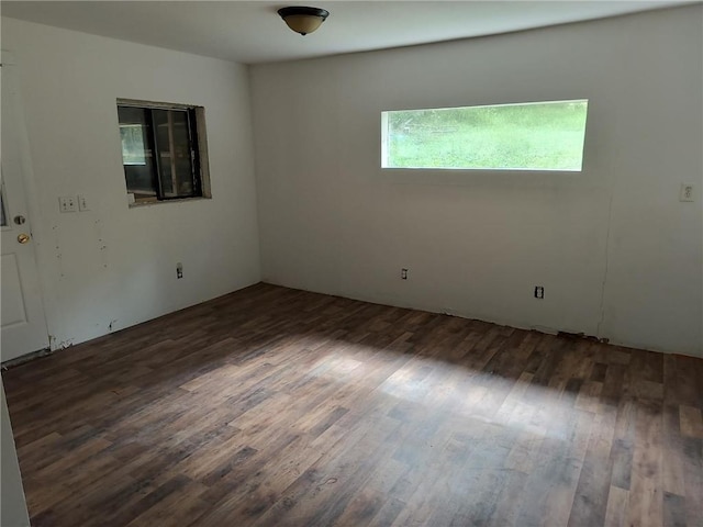 spare room with dark hardwood / wood-style flooring