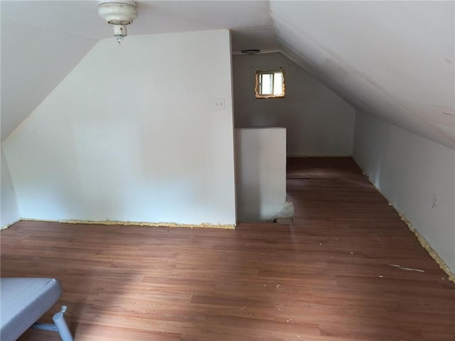 bonus room featuring dark hardwood / wood-style flooring and lofted ceiling