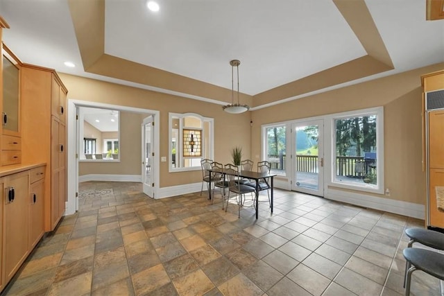 dining area with a raised ceiling