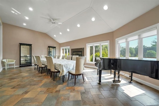 dining room with ceiling fan and vaulted ceiling