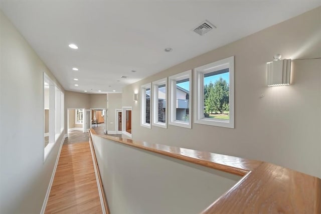 hallway with light hardwood / wood-style floors