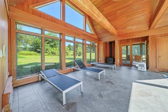 sunroom / solarium with a wood stove and a wealth of natural light