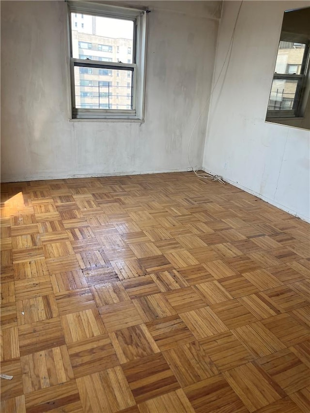 unfurnished room with light parquet flooring