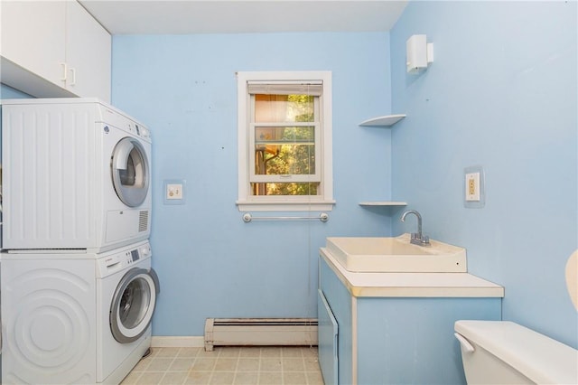 washroom with stacked washing maching and dryer, baseboard heating, and sink