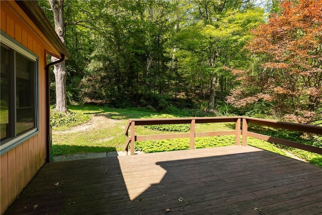 wooden terrace with a lawn