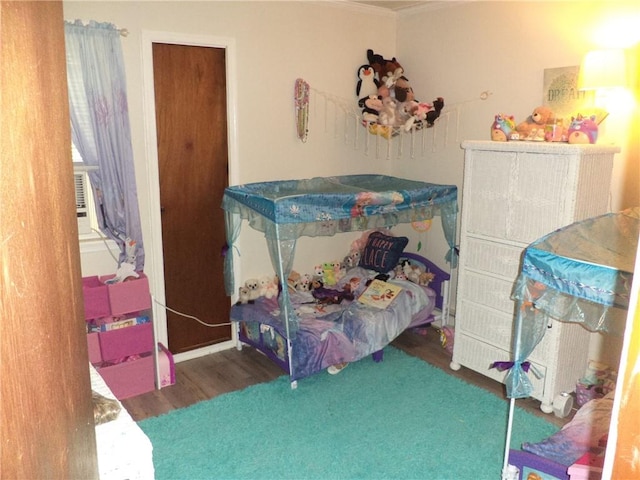 bedroom featuring cooling unit and dark wood-type flooring