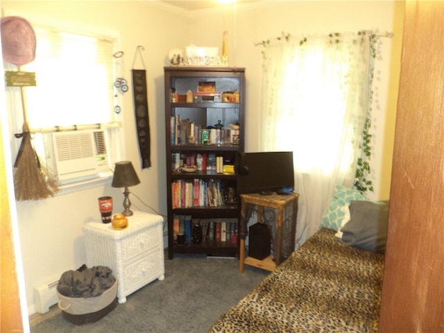 living area with crown molding, cooling unit, and dark carpet