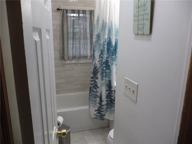 bathroom with tile patterned flooring, shower / bath combination with curtain, and toilet