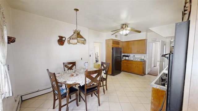 tiled dining room featuring baseboard heating and ceiling fan