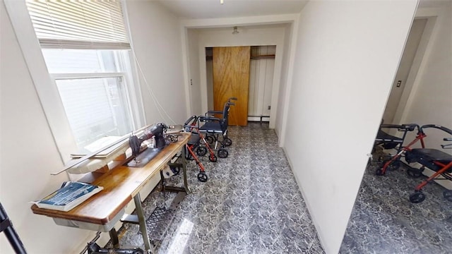 hallway featuring a baseboard heating unit