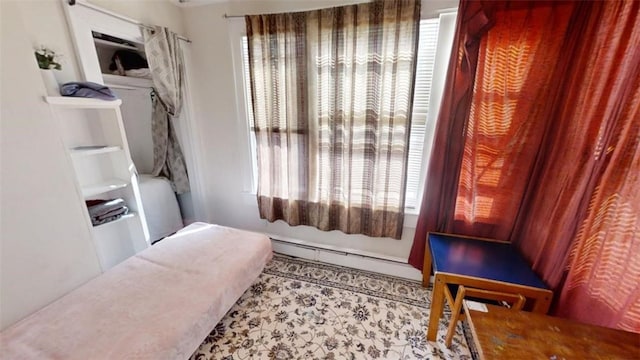 bathroom with a wealth of natural light and a baseboard radiator