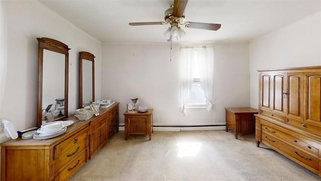 interior space featuring crown molding, ceiling fan, and a baseboard heating unit