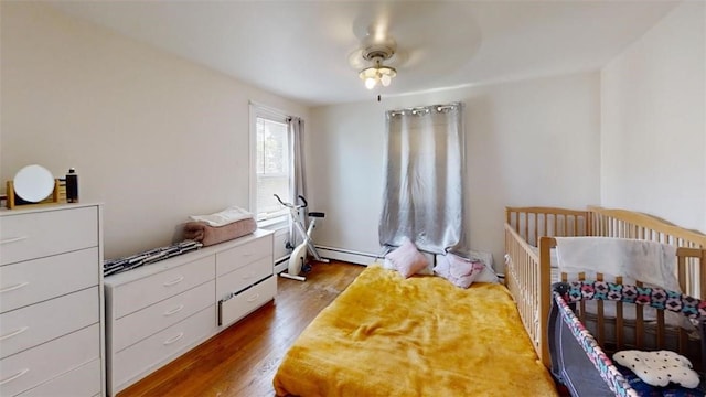 bedroom featuring ceiling fan and dark wood-type flooring