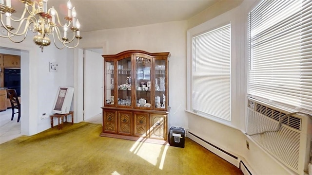 carpeted dining space with a notable chandelier and baseboard heating