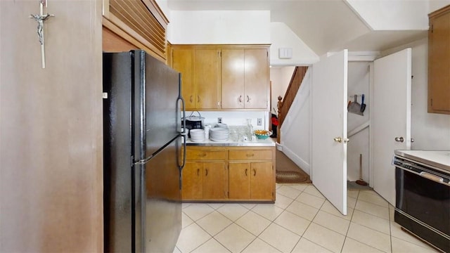 kitchen featuring light tile patterned flooring and black appliances