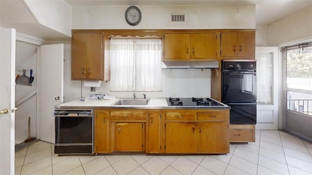 kitchen with sink, light tile patterned floors, and black appliances