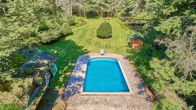 view of pool with a lawn