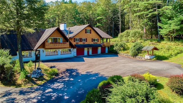 432 Black Forest Rd, Glen Spey, NY 12737 - view of front facade featuring driveway, a garage, a chimney, and a forest view
