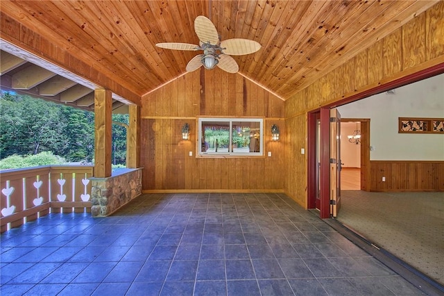 interior space featuring wood ceiling, ceiling fan, dark tile patterned flooring, lofted ceiling, and wood walls