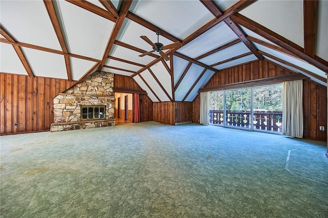 unfurnished living room with ceiling fan, a fireplace, carpet floors, and vaulted ceiling