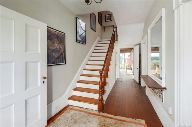 staircase with hardwood / wood-style floors