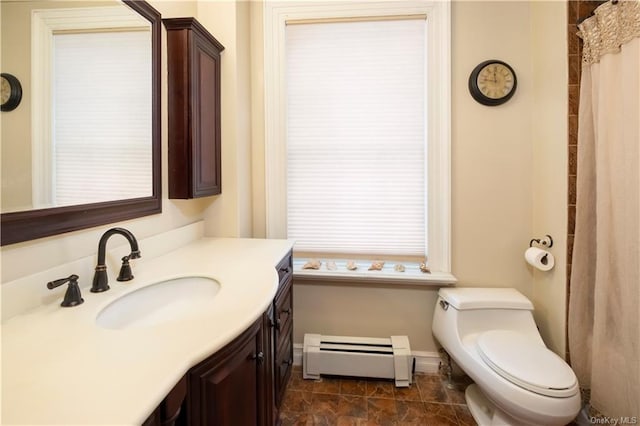 bathroom featuring vanity, toilet, and baseboard heating