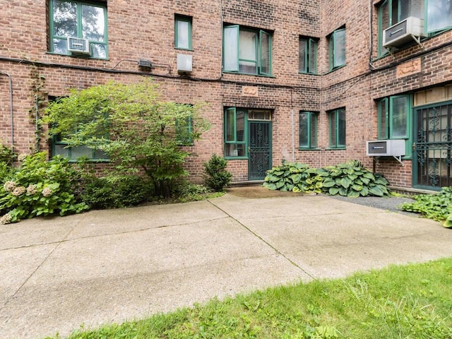 view of exterior entry with a patio