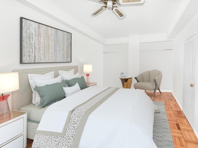 bedroom with ceiling fan and parquet floors