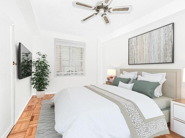 bedroom with light parquet flooring and ceiling fan