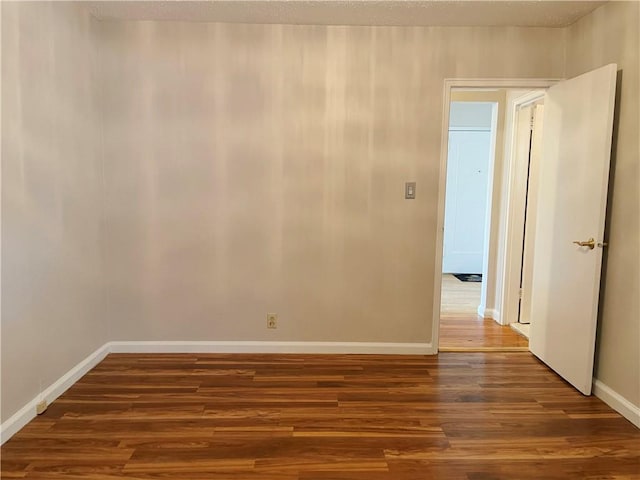 empty room featuring dark hardwood / wood-style flooring