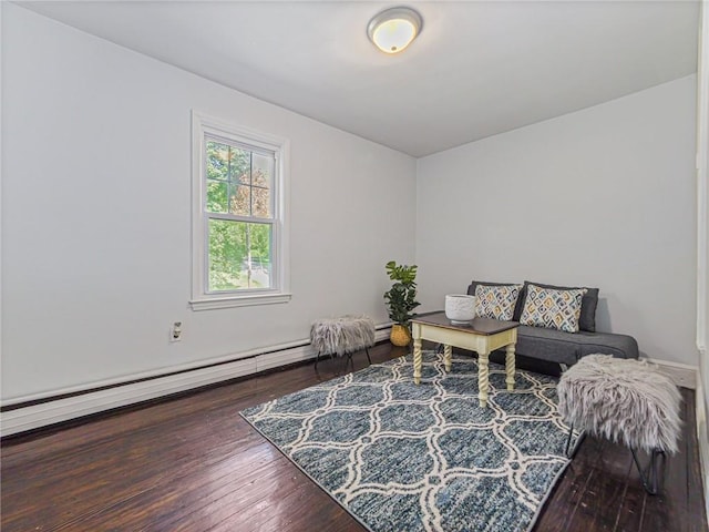 sitting room with baseboard heating and hardwood / wood-style floors