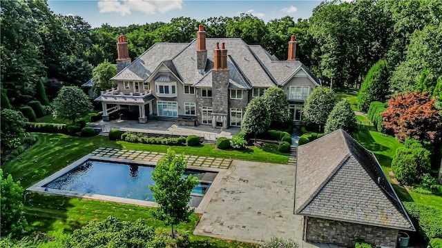 back of property featuring a yard and a patio