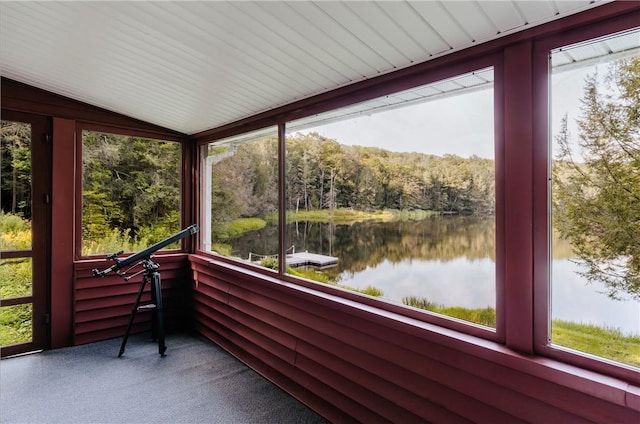 unfurnished sunroom with a healthy amount of sunlight, a water view, and vaulted ceiling